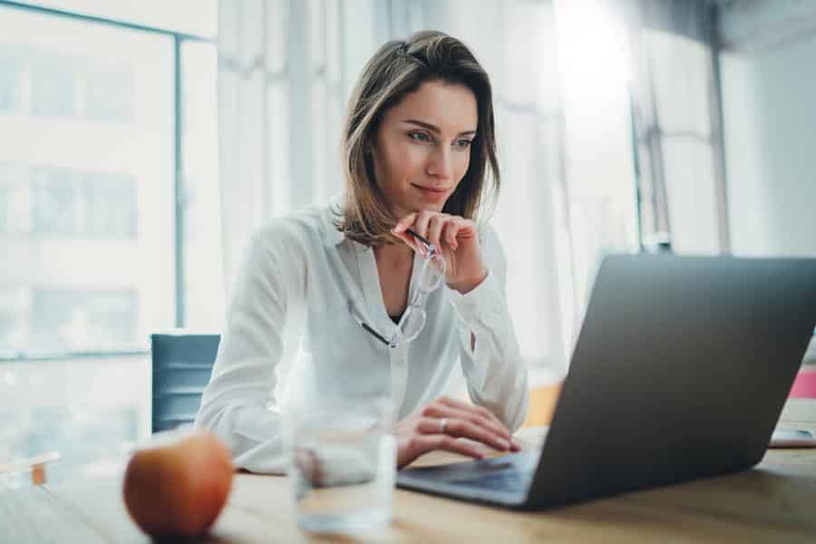 Confident businesswoman working on laptop at her workplace at modern office.Blurred background. hotline transformation